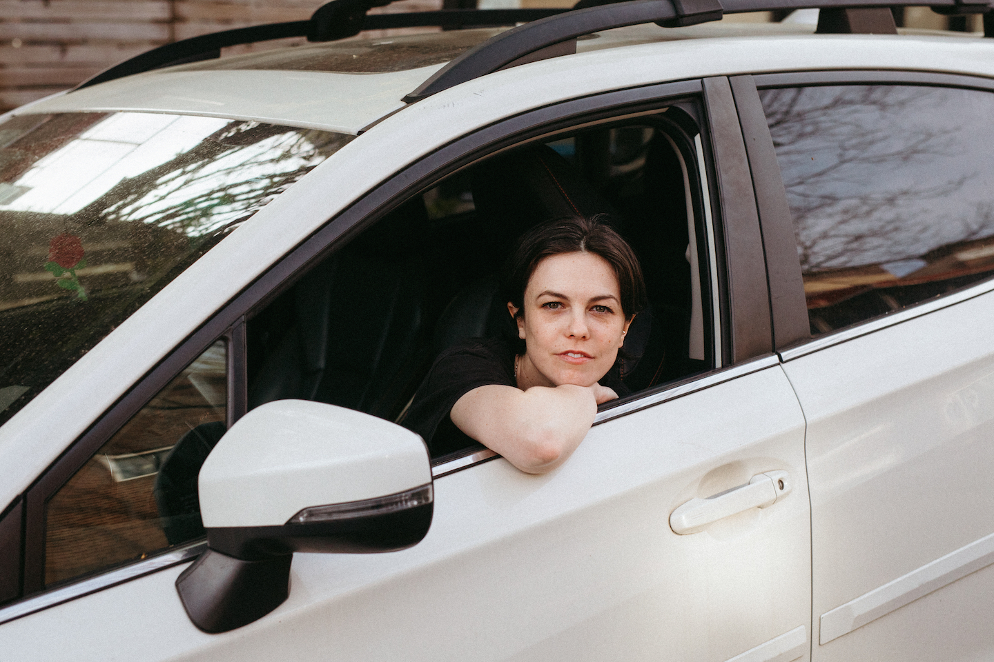 Maggie Millner leaning out of a car window